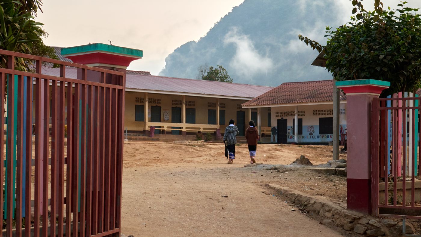 A rural village school beneath misty mountains in Nong Khiaw, Laos